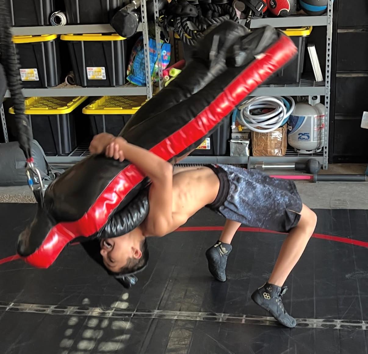 Coach working takedown drills with a student
